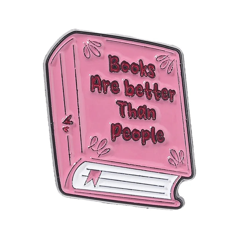 Pink enamel pin featuring text that reads Books Are better Than People on a book design