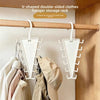 V-shaped double-sided clothes hanger storage rack mounted on a wooden rod in a closet.