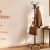 A freestanding metal coat rack with 14 sturdy hooks displayed in a bright room setting.