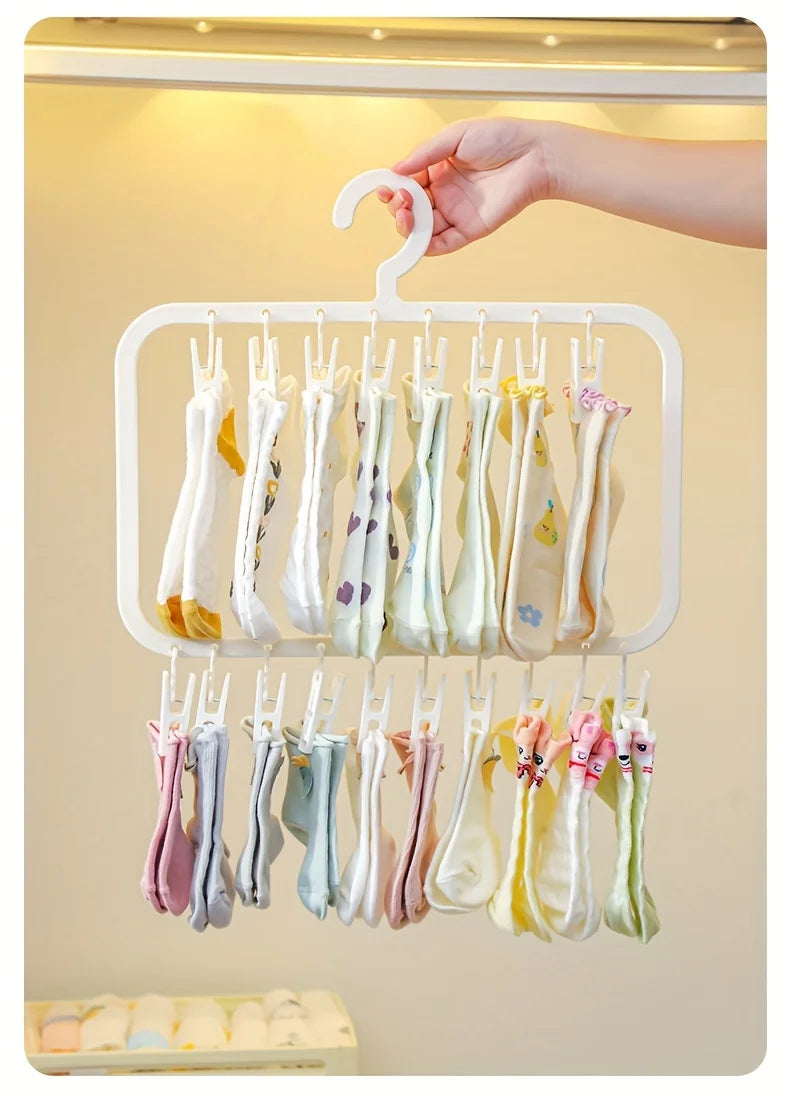 A white clip laundry drying rack with various colored fabric clips hanging from it.