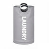 A gray extra-large foldable laundry basket with black padded handles.