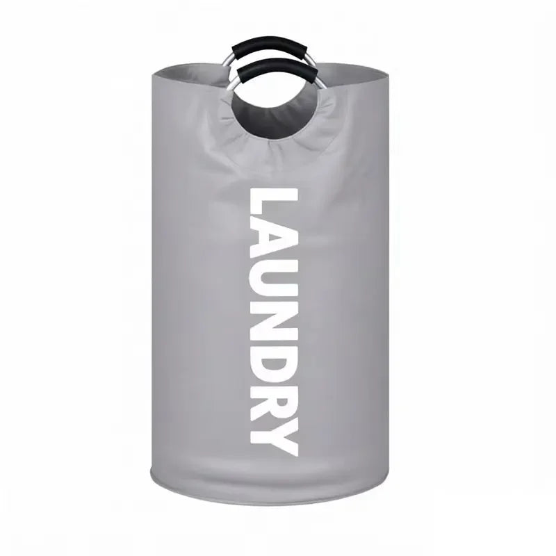 A gray extra-large foldable laundry basket with black padded handles.