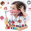 A child is playing with a wooden bead maze toy featuring colorful beads and strings on a wooden base.