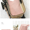 A pink breathable knit swaddle blanket is shown being used to wrap a newborn baby in a pram.
