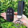 A black silicone key fob cover with buttons for Jeep, Dodge, and Chrysler is shown attached to a silver chain.