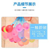 A close-up shot of numerous pink and colorful water balloons being prepared for use.