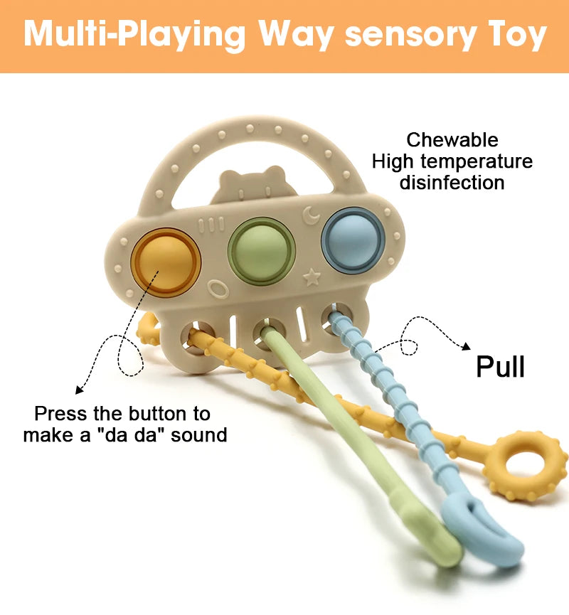 A silicone bear teether toy with multiple colored buttons and a pull string for sensory play