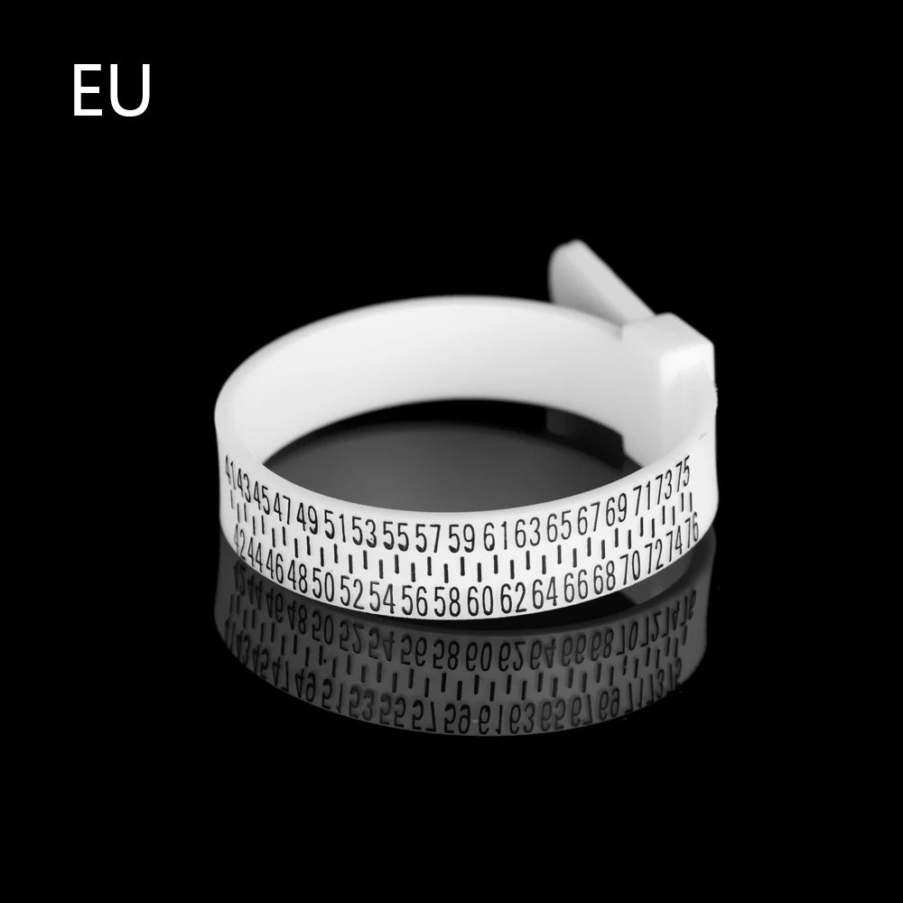 A white ring sizer measuring tool with a magnifying lens is shown against a black background.