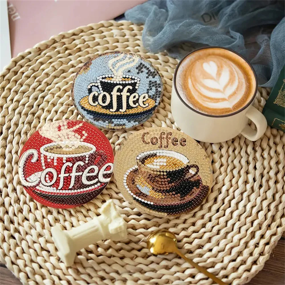 A set of sparkling diamond painting coasters featuring coffee cup designs and a ceramic mug.