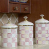 Three decorative porcelain storage jars with a pink and cream checkerboard pattern.