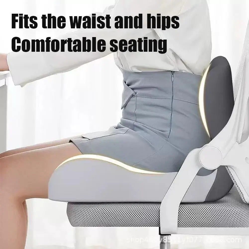 A person is shown sitting comfortably in a gray ergonomic car seat cushion designed to fit the waist and hips.