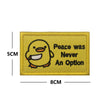 A yellow embroidered patch featuring a cartoon duck with text that reads Peace was Never An Option