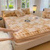 A tan luxury faux fur fitted sheet and pillowcase set displayed on a bed with natural light.