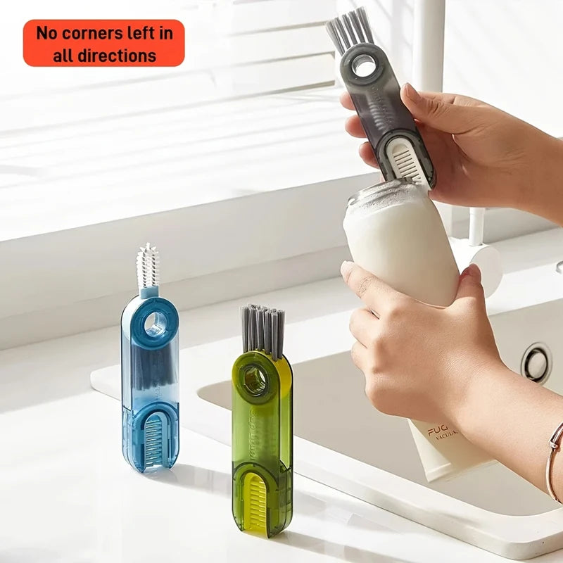 A hand is cleaning a glass with a silicone brush set, including a cup and bottle cleaning brush.