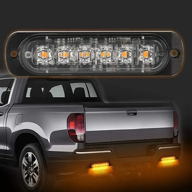 LED strobe side marker lights installed on the rear of a silver pickup truck.