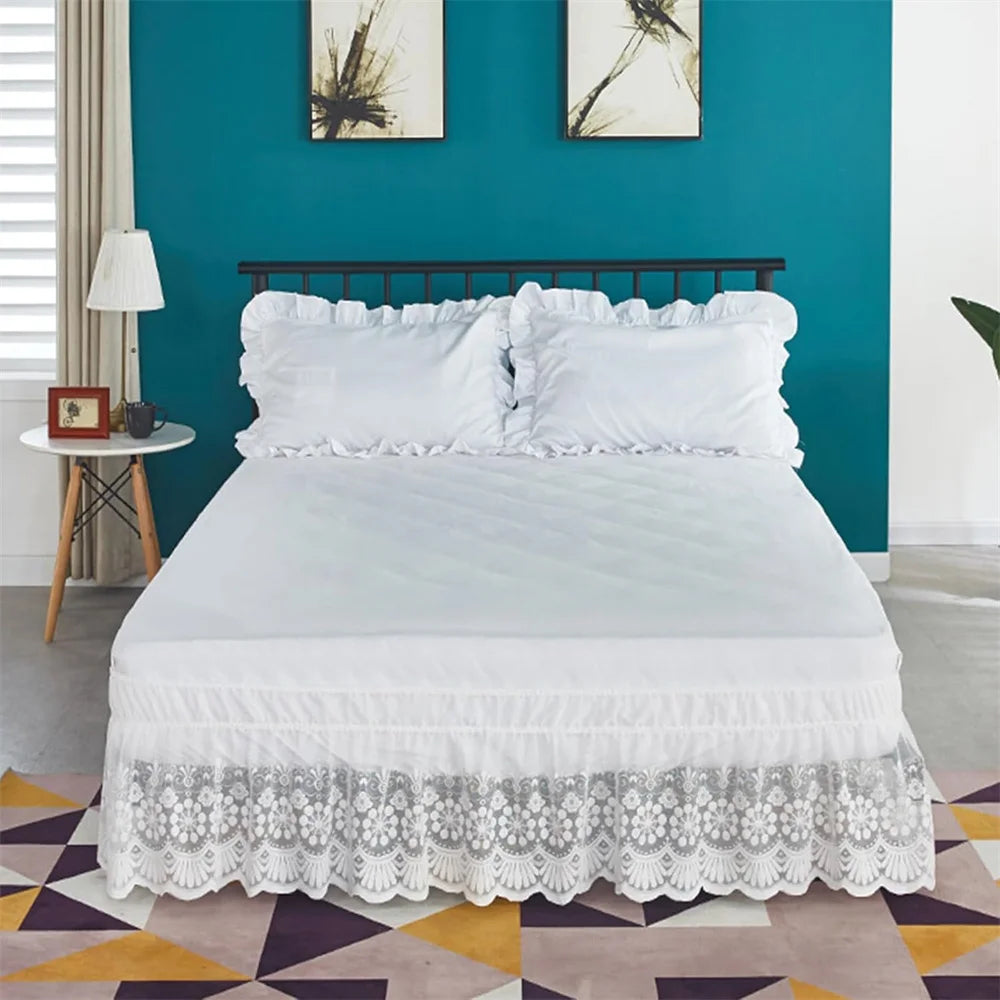 White ruffled lace bed skirt with elastic fit on a bed in a teal room.