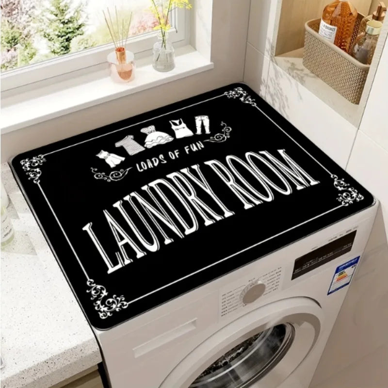 A black top cover mat for a laundry room with white lettering that reads LOADS OF FUN and LAUNDRY ROOM