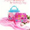 A pink butterfly bag makeup set with various cosmetic items and a pink satin fabric.
