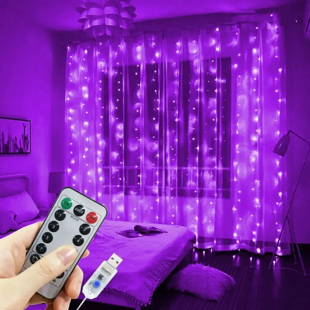 A hand holds a remote control for USB LED curtain string lights illuminating a purple sheer curtain.
