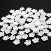 A pile of 100 white acrylic pearl spacer beads for jewelry making.