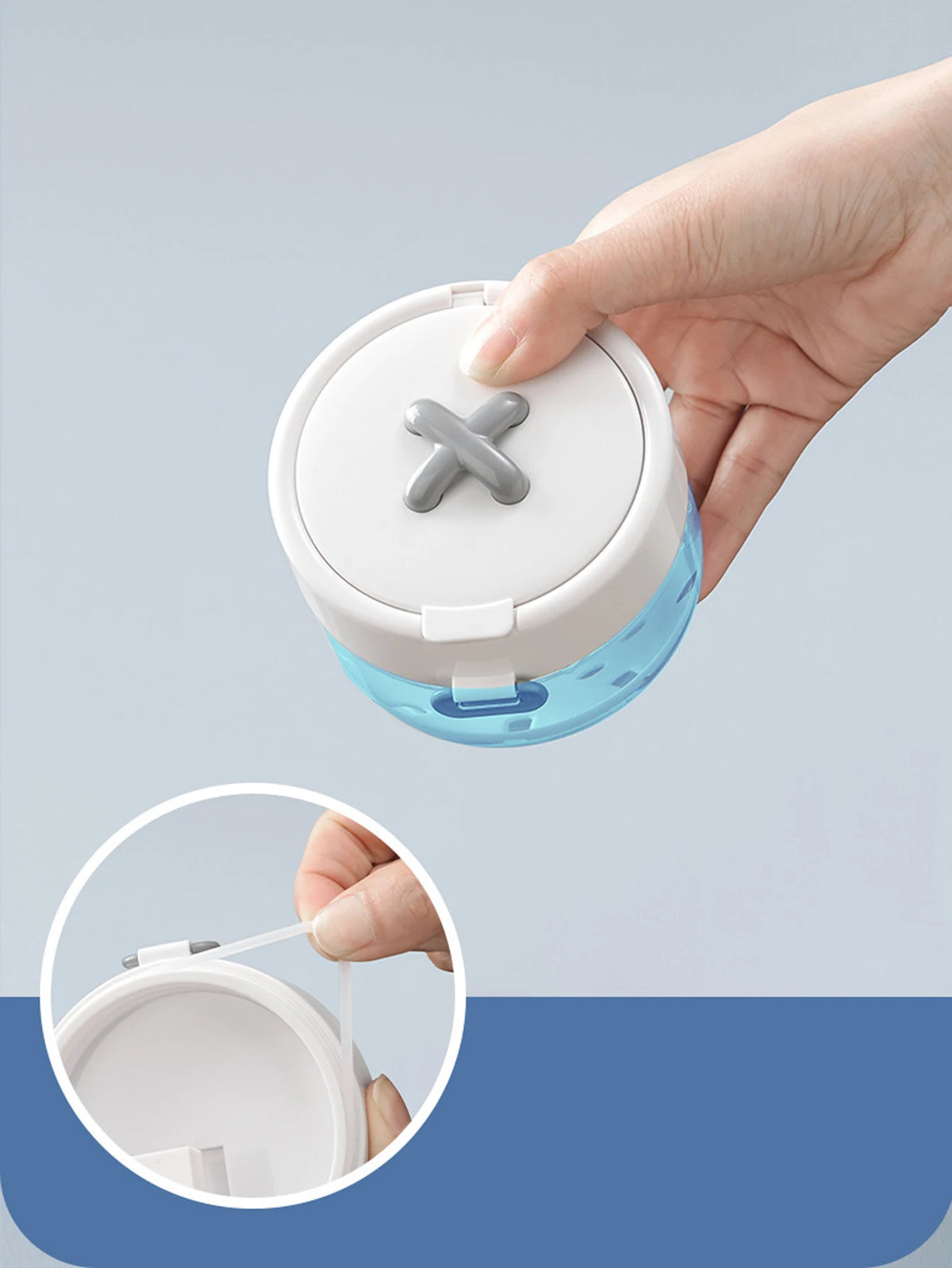 A hand is holding an open portable denture case with a cleaning brush storage compartment.