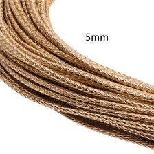 Close-up of a 5mm braided leather cord spool showing multiple widths and texture.