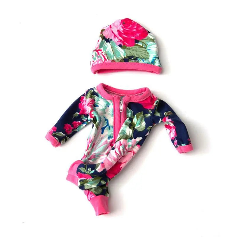 A pink and floral jumpsuit outfit for a baby doll featuring pink and green fabric.