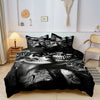 A black duvet cover featuring a detailed monochrome sugar skull design with floral accents on a bed.