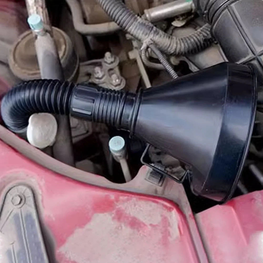 A black engine refueling funnel with a filter attached is visible in the engine bay of a red vehicle.