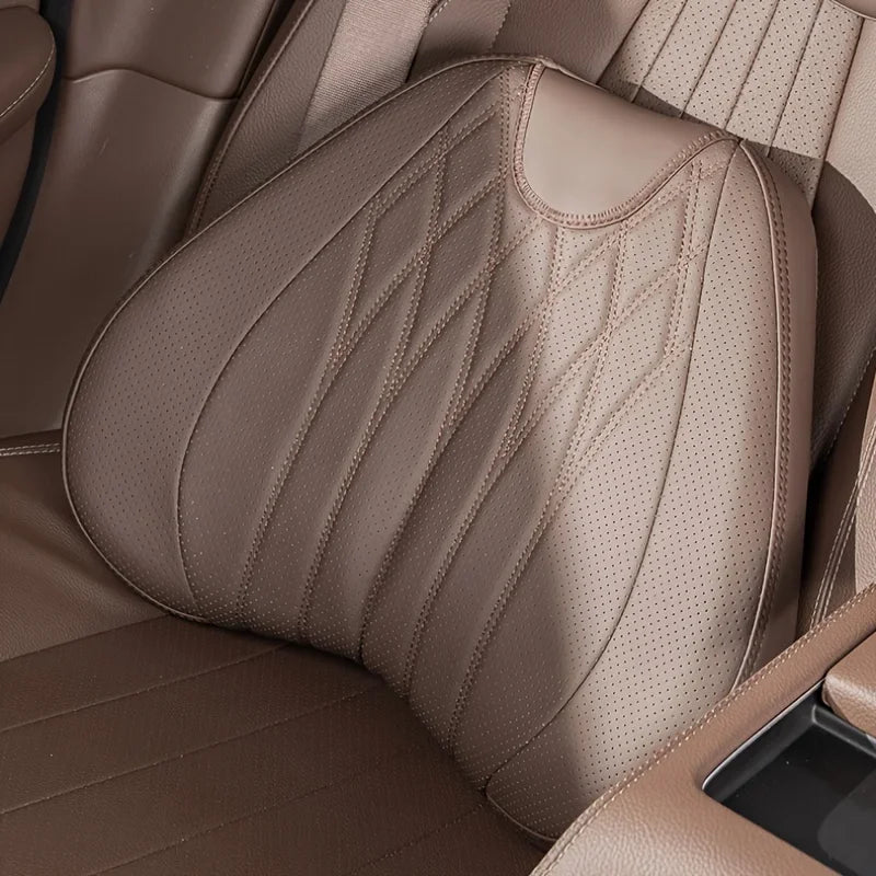 A tan memory foam lumbar support and neck pillow set placed on a car seat cushion.