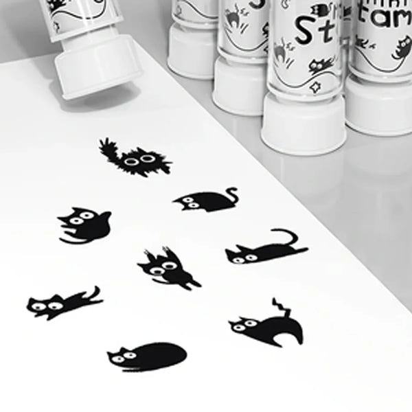 A set of eight black cat stamps featuring various poses and expressions on a white surface.