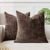 A dark brown handwoven chenille texture cushion cover resting on a light-colored sofa.