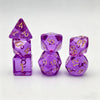 A set of seven translucent purple acrylic polyhedral dice, including a tetrahedron and dodecahedron.