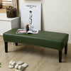 A dark green waterproof PU stretch bench cover placed on a wooden floor in a bright room.