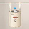 A beige foldable foot bath basin with a blue lid and storage bag hanging from a metal bar.
