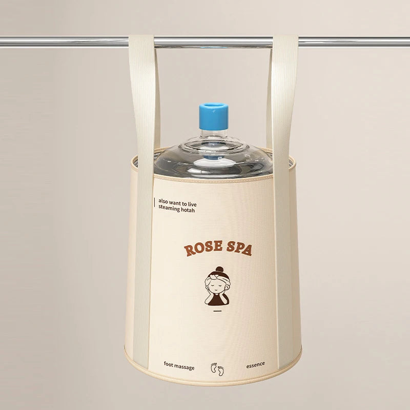 A beige foldable foot bath basin with a blue lid and storage bag hanging from a metal bar.