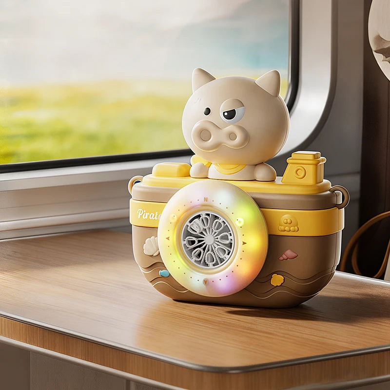 A yellow pig-shaped camera holds a glowing bubble machine with lights and music on a wooden surface.
