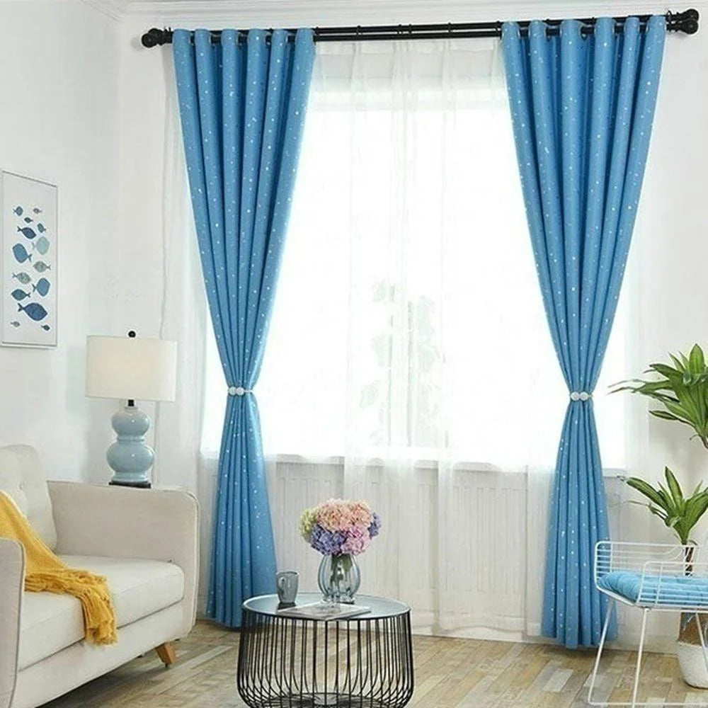 Light blue magnetic curtain clips on a window with sheer white curtains and blue fabric drapery.