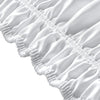 Close-up of a white adjustable wrap-around bed skirt featuring elegant ruffles and gathered fabric.
