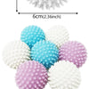 A collection of reusable laundry balls in white, light blue, and purple colors.