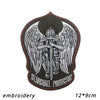 Embroidery of an Archangel St. Michael with wings on a dark patch.