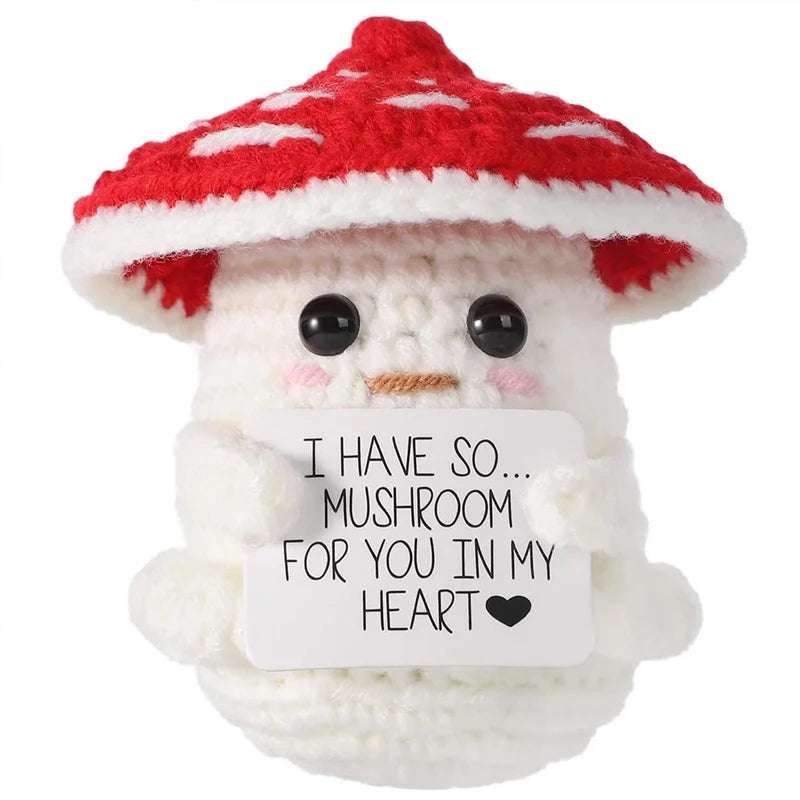 Handmade crochet mushroom animal doll with a red and white spotted cap and a message card