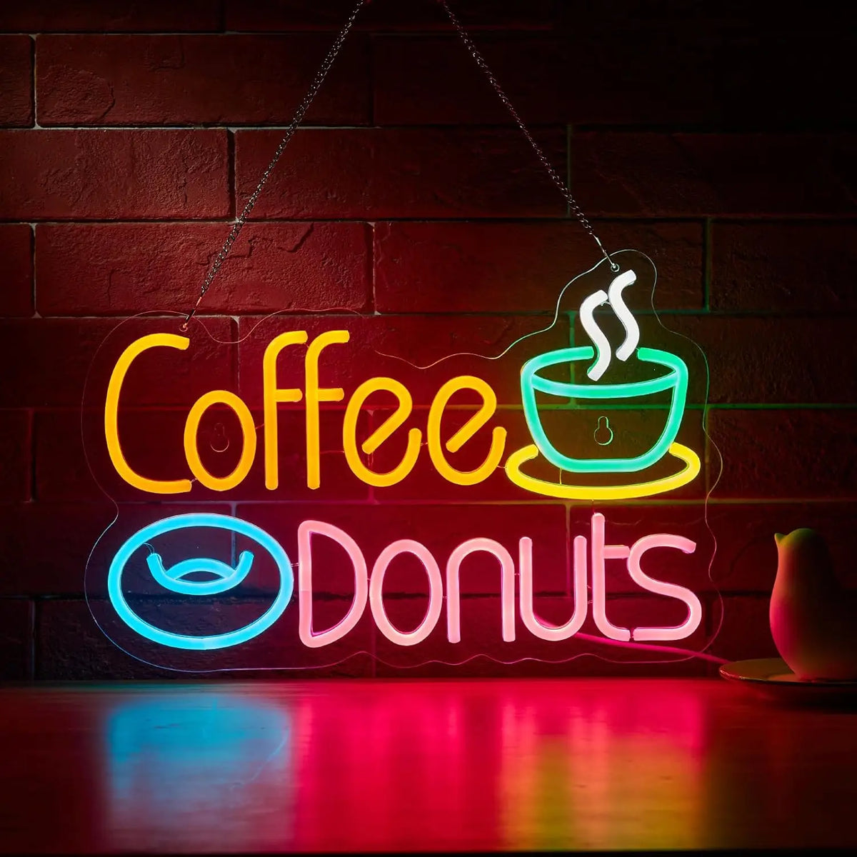 Neon sign displaying Coffee and Donuts in bright neon colors on a brick wall.