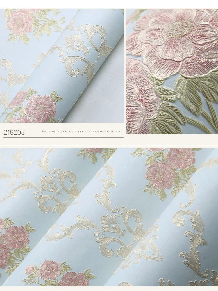 Close-up view of light blue floral wallpaper featuring pink and gold carved leaves and roses.
