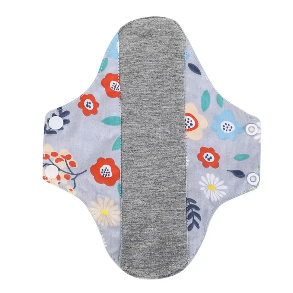 Reusable cotton menstrual pads featuring a gray absorbent pad and colorful floral designs.