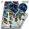 Cotton Satin Grand Wax fabric featuring blue and gold floral patterns