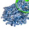 A pile of tumbled blue and gray crystal stone chips in a green bowl.