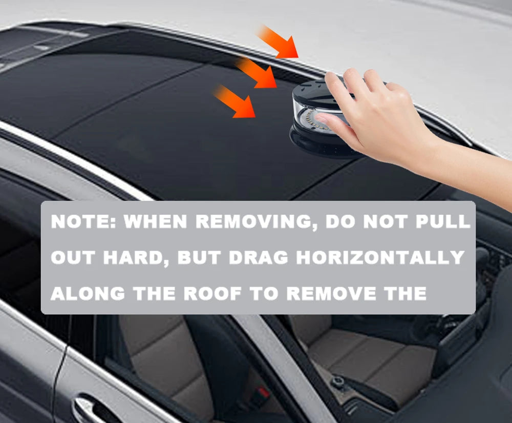 A hand is removing a magnetic mount LED emergency strobe light from the roof of a car.