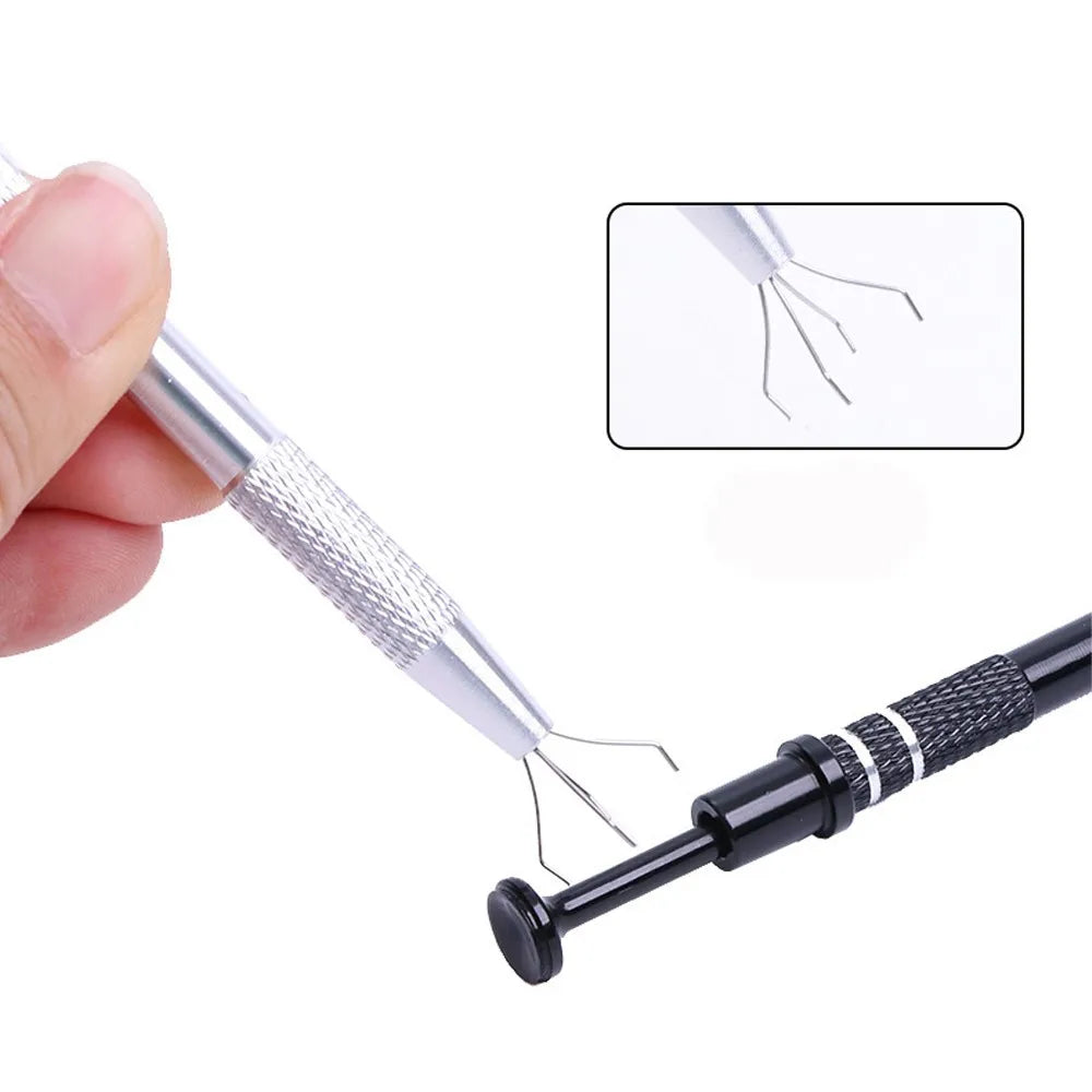 A hand holds a silver precision pick-up claw with four prongs, demonstrating the tool for jewelry making.