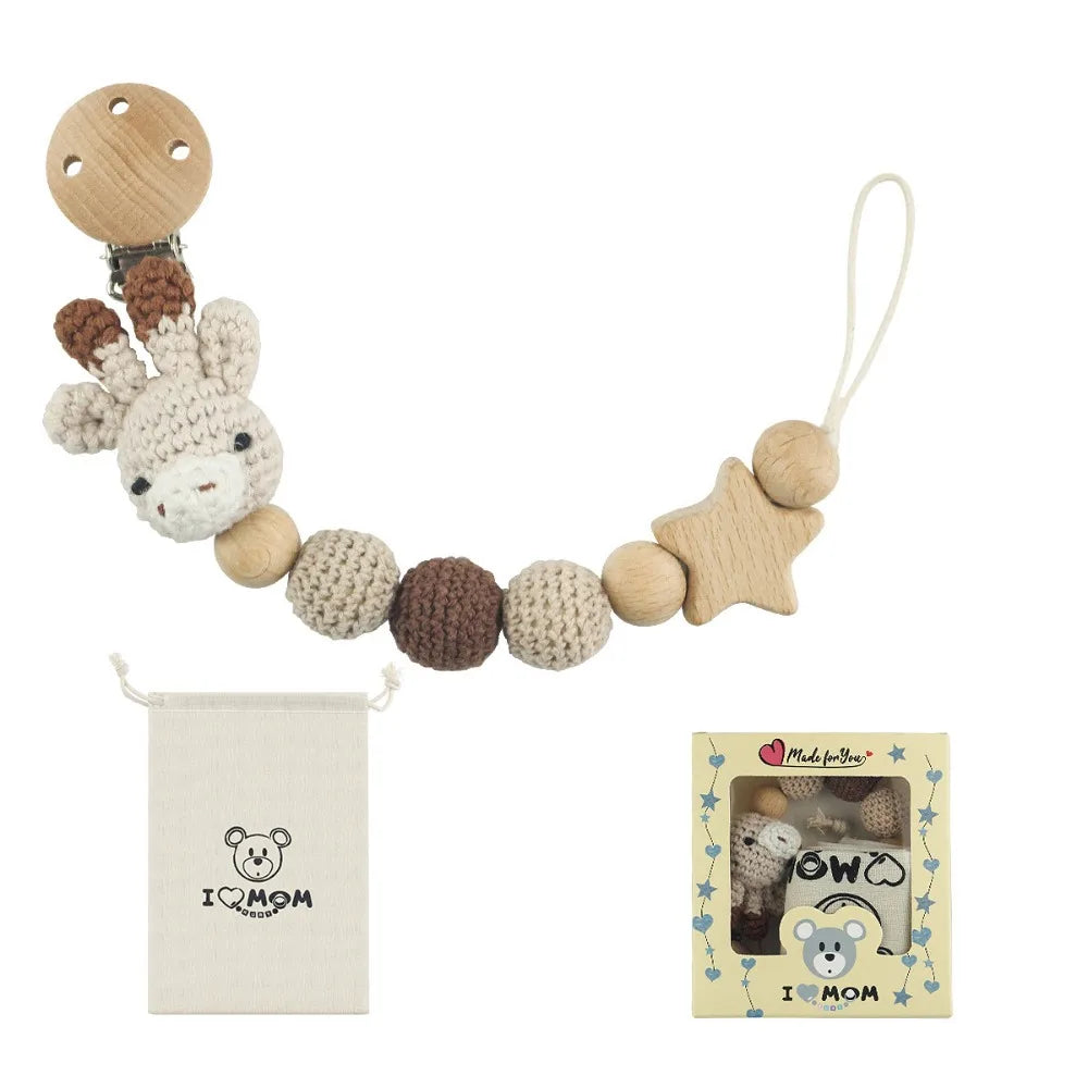 Wooden pacifier clip with crochet beads on a chain, packaged for a baby